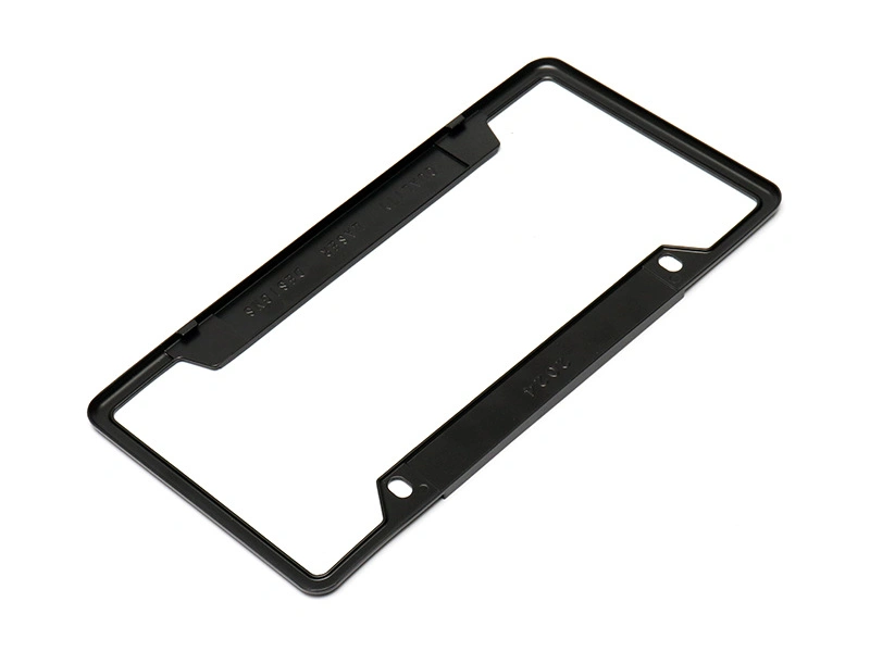 Angled view of a black zinc die cast automotive frame showing formed edges and bosses